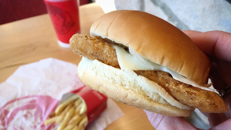 Hand holding Monterey Jack Crispy chicken sandwich