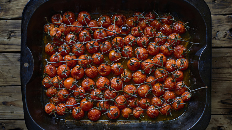 Roasted on-the-vine cherry tomatoes in black baking pan