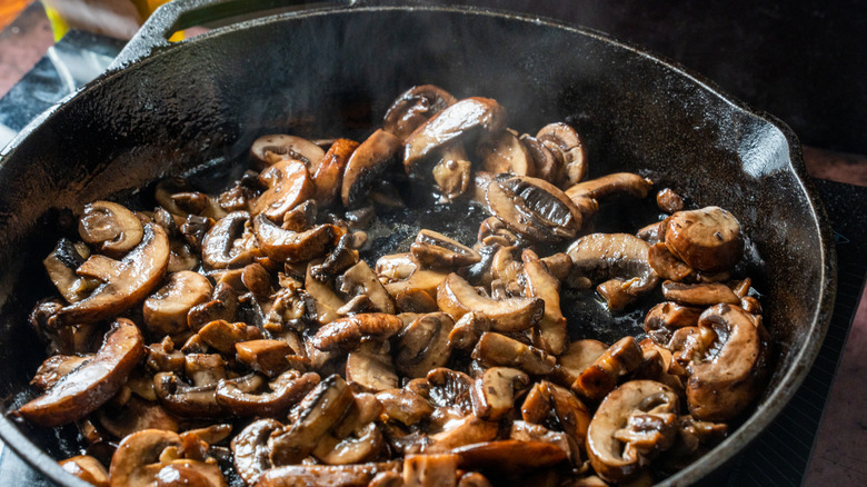 cast iron pan filled with sauteed mushrooms