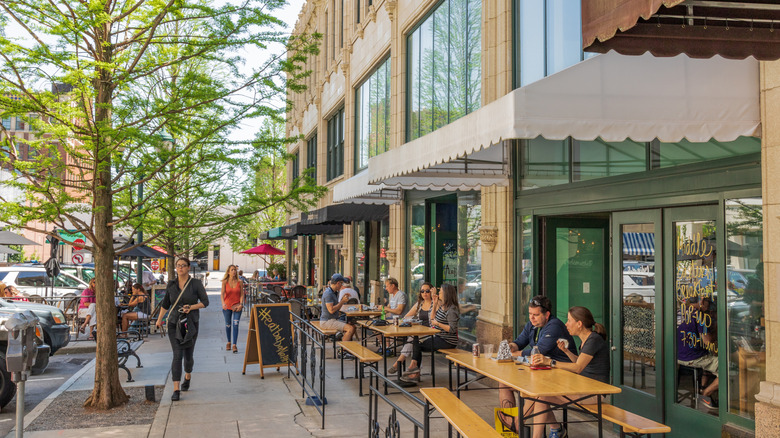 Diners sitting outside restaurants on a street in Asheville, North Carolina
