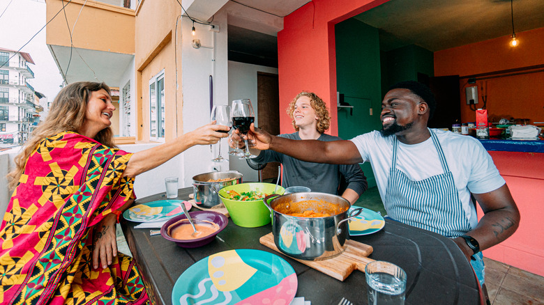 Three people dining on a balcony in Panama City