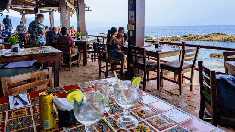 Customers dining in a beachfront restaurant in Puerto Vallarta