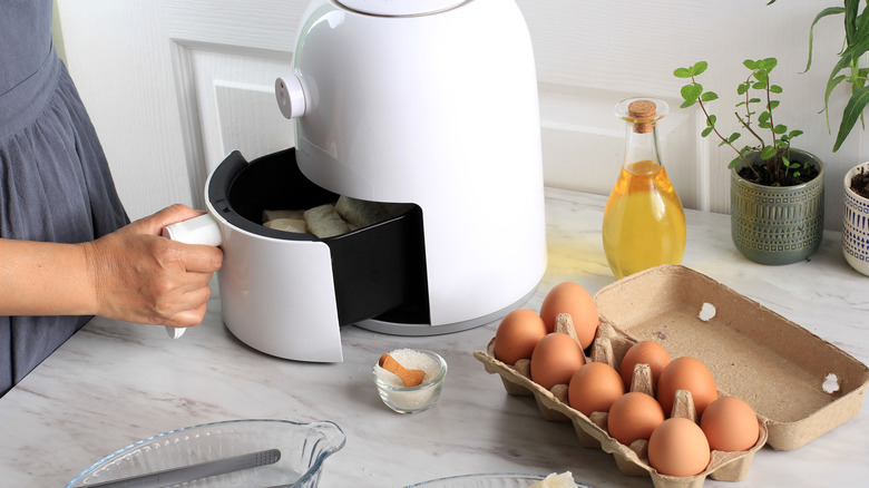 Air fryer and eggs on kitchen counter