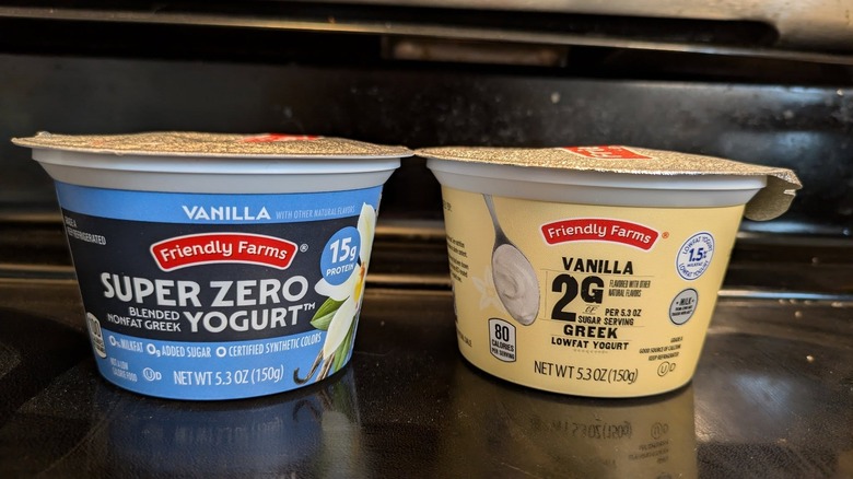 Two single-serving cups of Greek yogurt of different styles