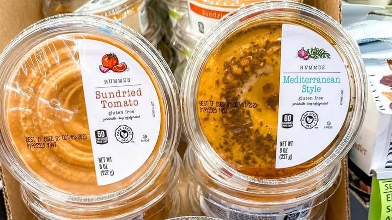 Sundried tomato and Mediterranean style hummus cartons on shelf at Aldi