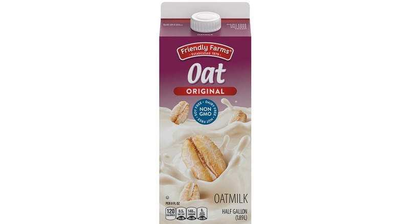 Carton of oat milk with depiction of oats splashing in creamy liquid on front