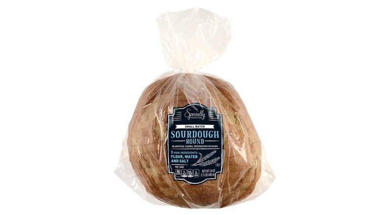 Round loaf of sourdough bread in plastic bag
