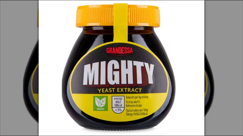 Mirrored image of Mighty yeast extract jar against white background