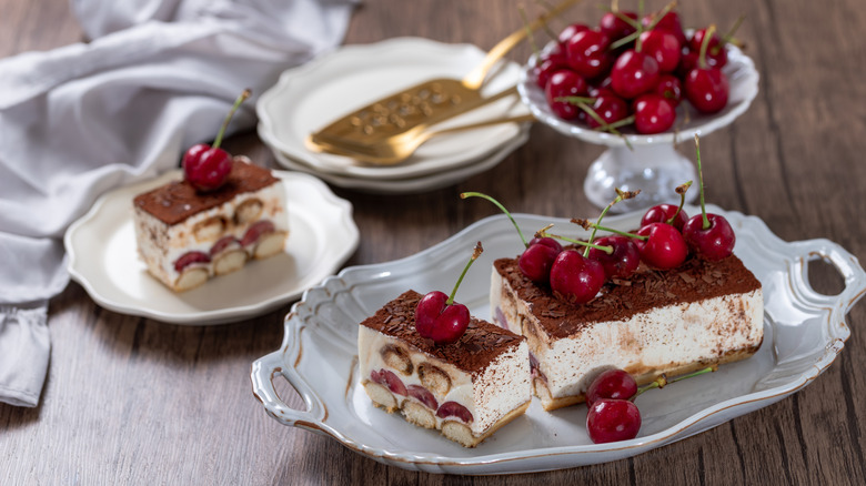 Plated tiramisu with cherries on top