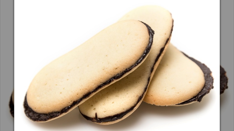 Three Milano cookies on white background