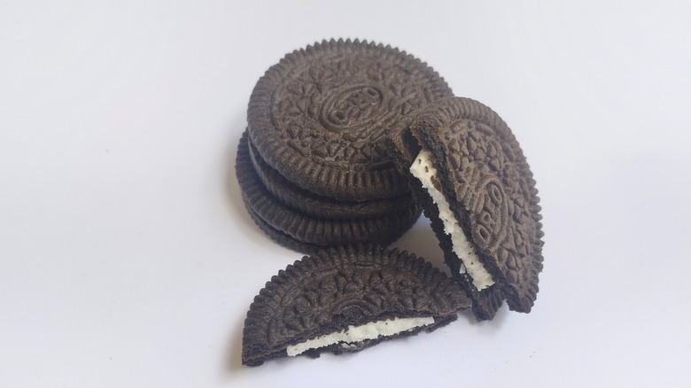 Stacked oreos with one oreo split in half showcasing the white cream
