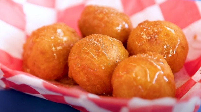 Balls of deep-fried butter in red and white paper-lined tray