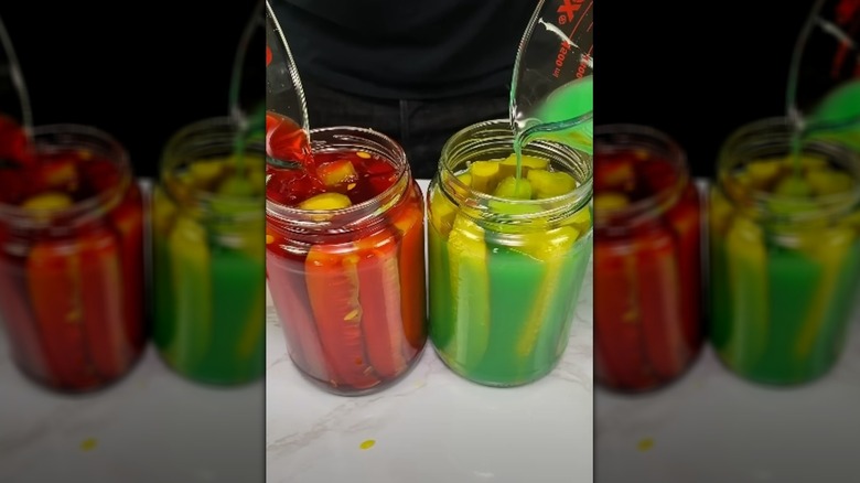 Pouring Kool-aid into jars of pickle spears
