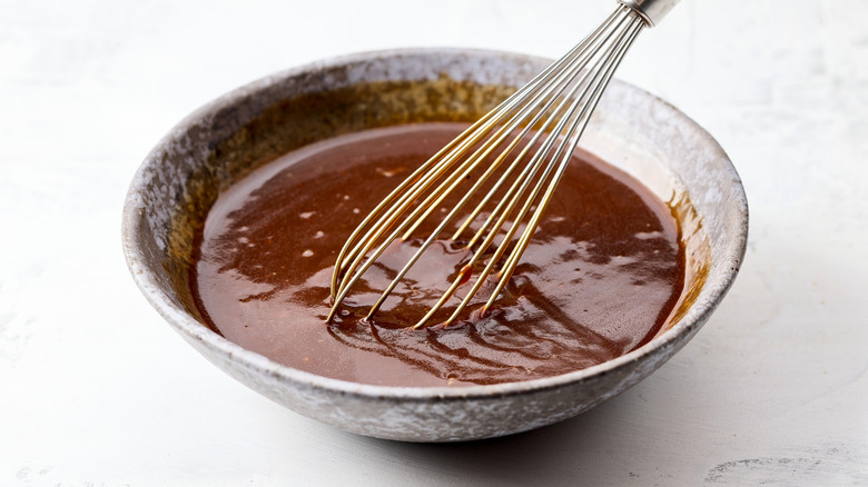 Whisking hoisin sauce in bowl