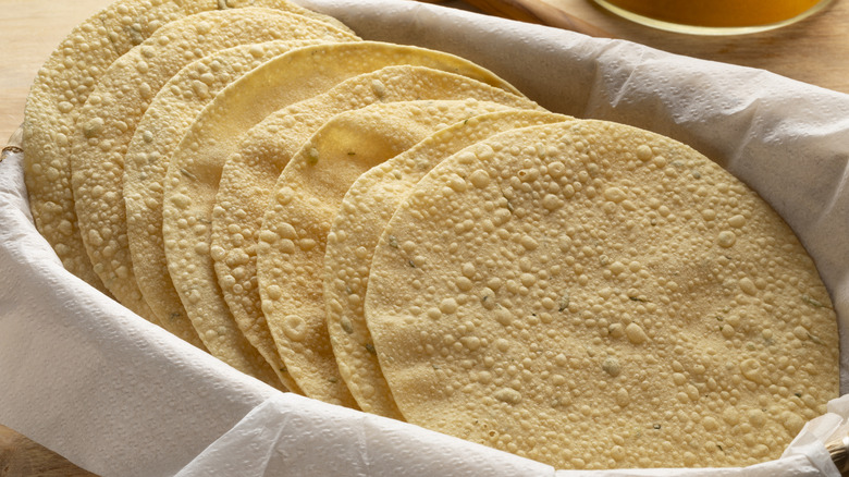 Fried papadum rounds in a basket