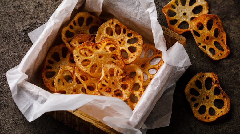 Lotus root chips in a parchment-paper-lined wooden box