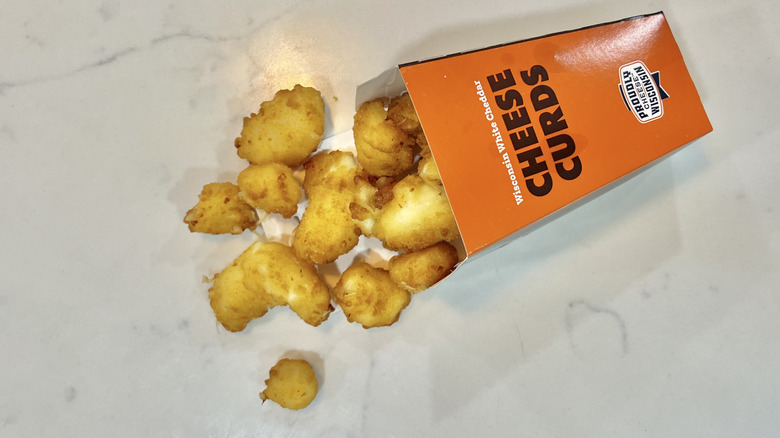 A&W cheese curds falling out of to-go container.