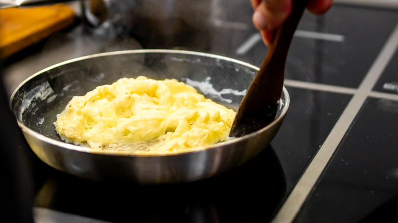 making scrambled eggs in a skillet