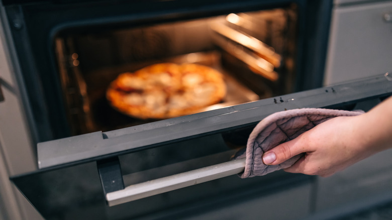 woman opening an oven door