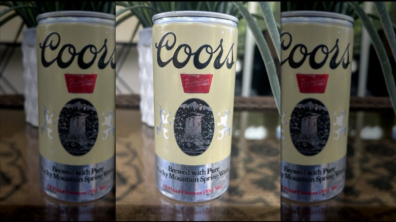Mirrored image of vintage Coors can with plant in background