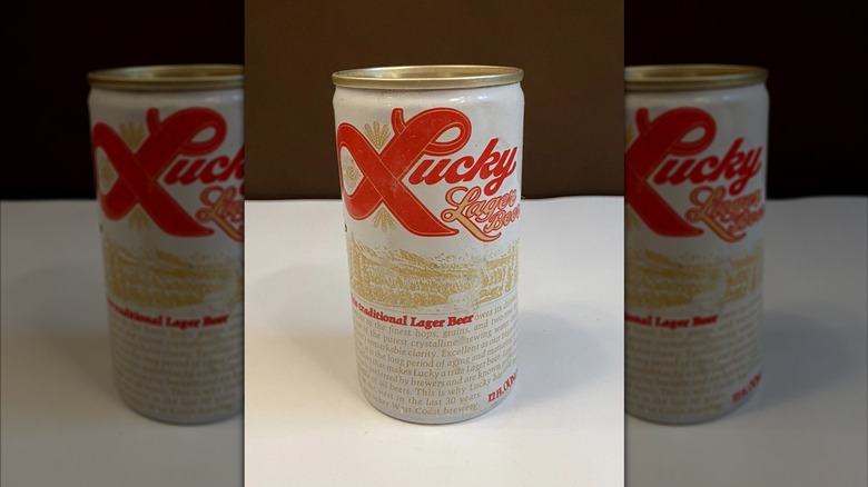 mirrored image of Lucky Lager can on white surface against brown background
