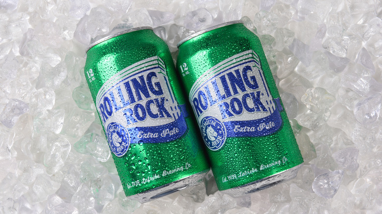 Two cans of Rolling Rock on ice