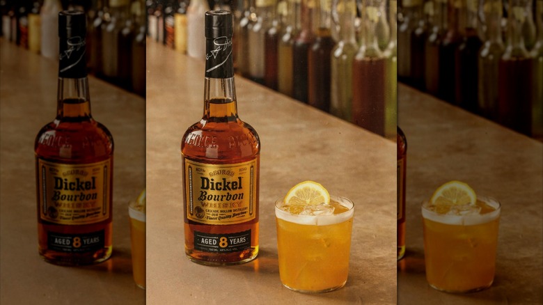 A bottle of George Dickel bourbon with a cocktail next to it