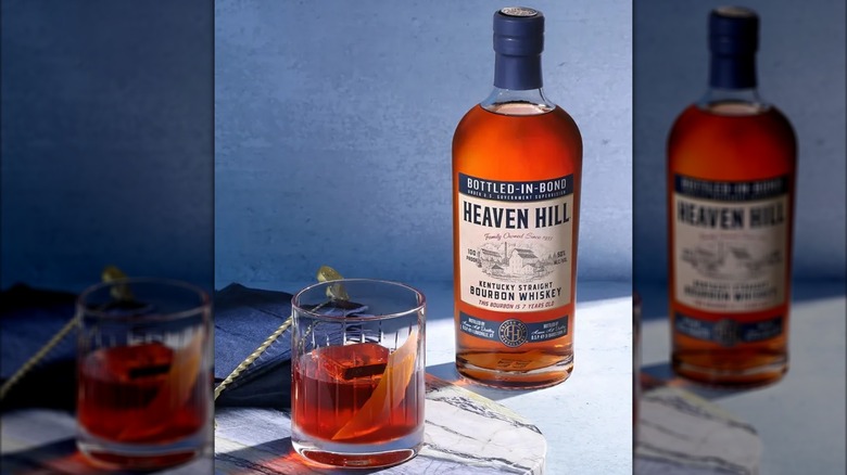 A bottle of Heaven Hill 7 year bourbon next to a cocktail