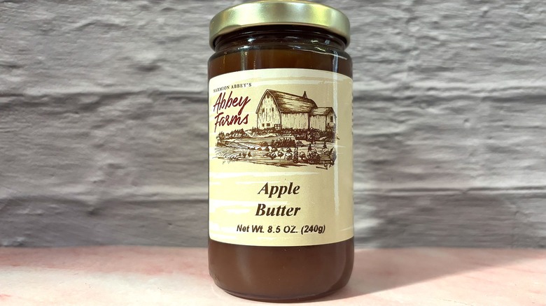 Jar of Abbey Farms Apple Butter on pink table