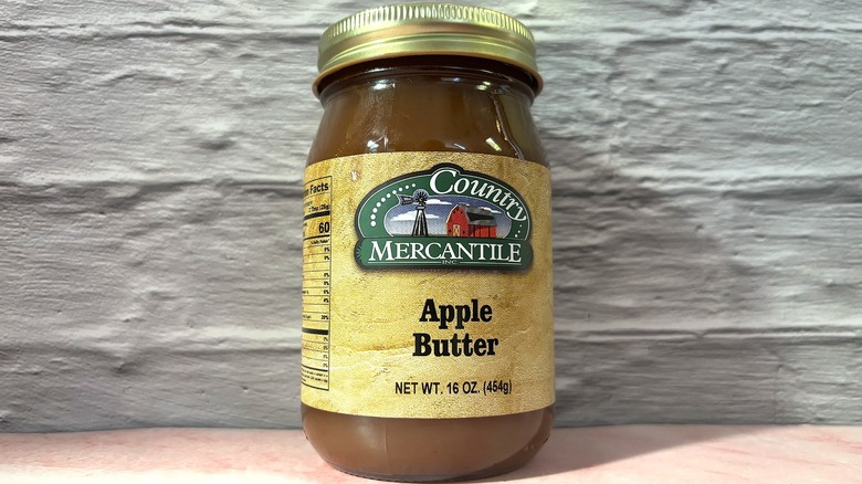 Jar of Country Mercantile Apple Butter on pink table