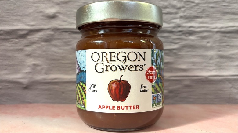 Jar of Oregon Growers Apple Butter on pink table