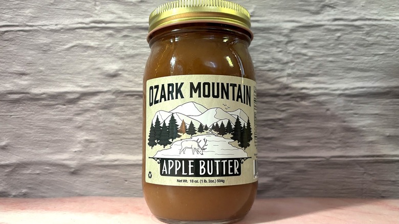 Jar of Ozark Mountain Apple Butter on pink table