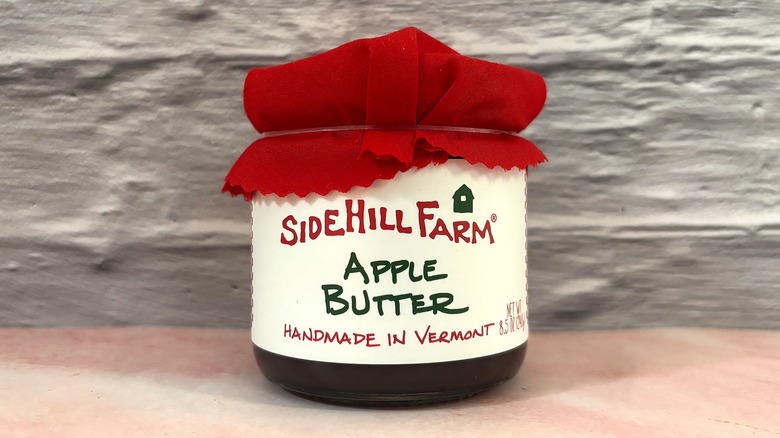 Jar of Sidehill Farm Apple Butter on pink table