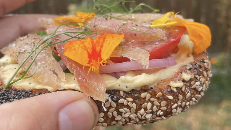 Sliced sesame and poppy bagel with toppings