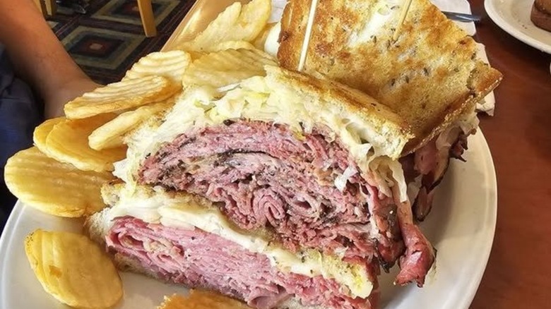 Pastrami sandwich on rye with chips