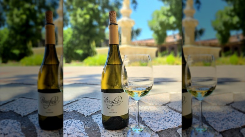 a bottle of viognier next to a glass of viognier