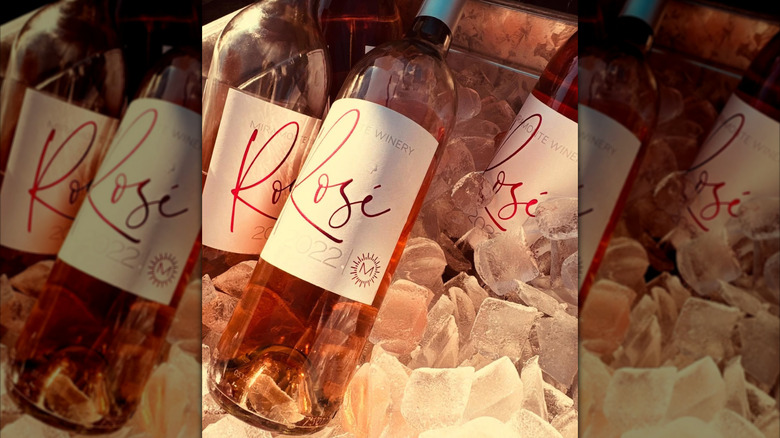 a couple of rose wine bottles
