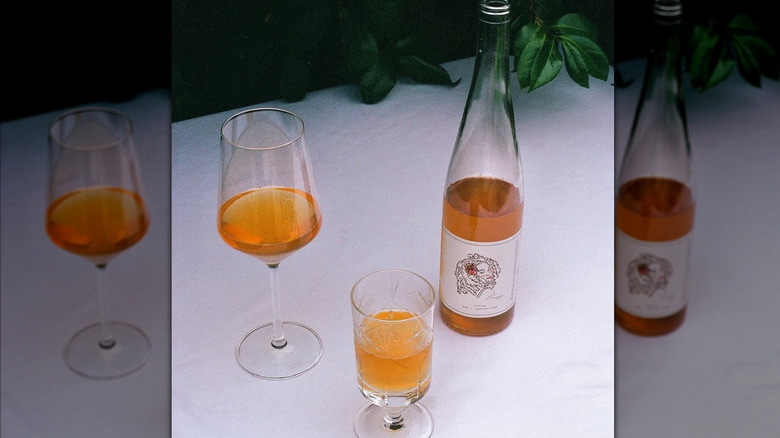 orange wine bottle with glasses