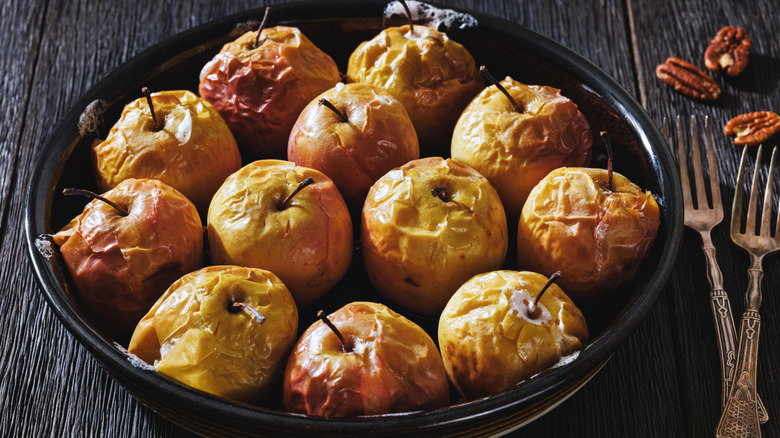 Whole baked apples in black baking dish