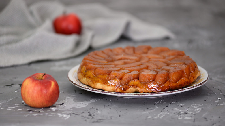 Thin tarte tatin on white serving plate