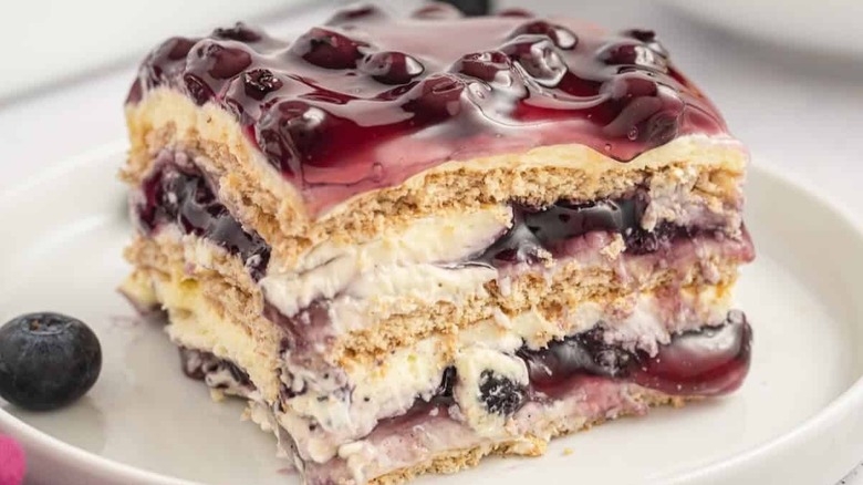 close up of a slice of blueberry ice box cake with a bite taken out of it