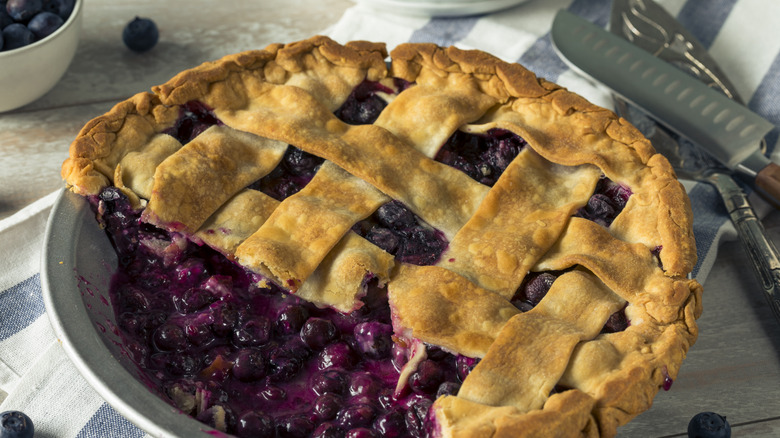 top view of blueberry lattice pie that's been cut into it showing filling