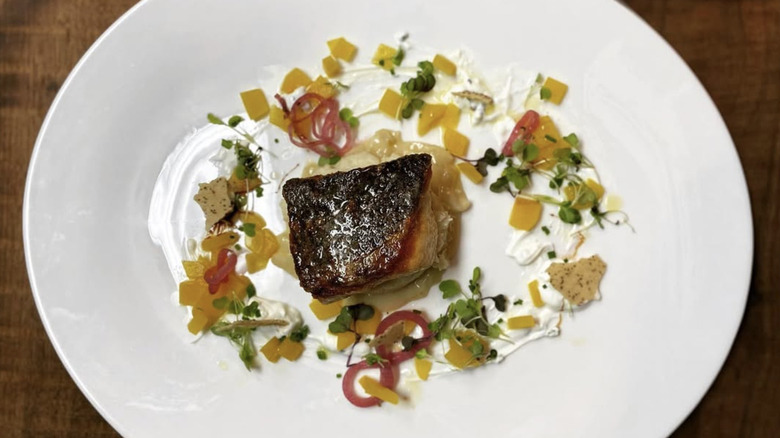 Top view of a seared trout dish on a white plate from Market Table Bistro in Lovettsville