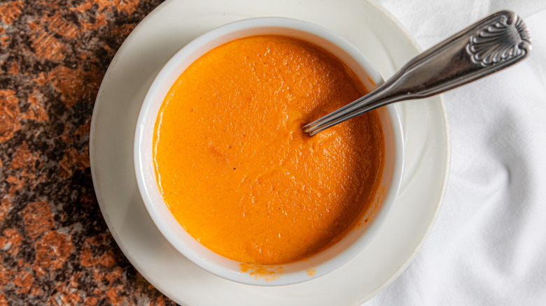 Bowl of tomato bisque with a spoon