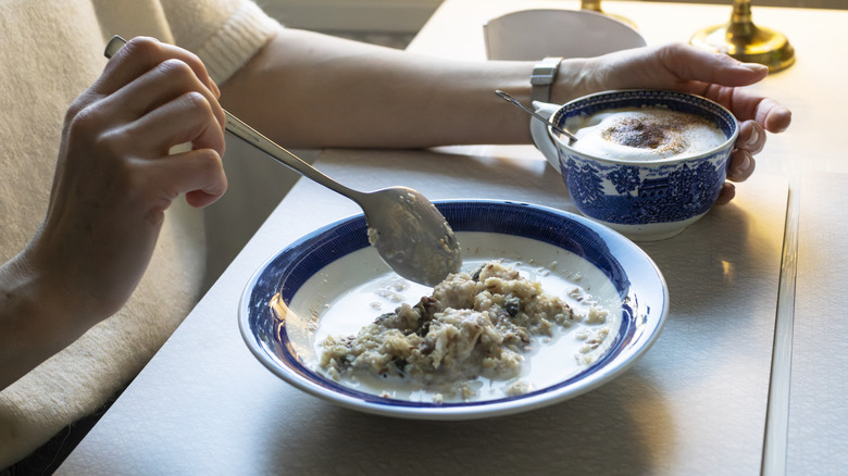 Woman eating porridge with a spoon