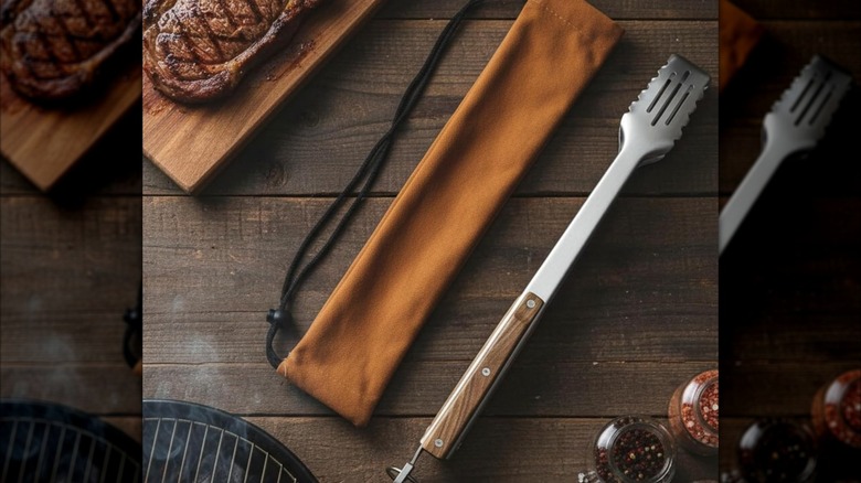 Boxiki 17-inch Grill Tongs with bag on wooden table with steak