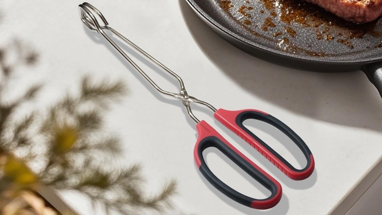 Hinmay scissor grip tongs on cutting board