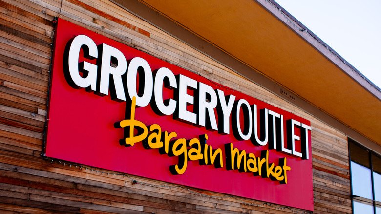 Red Grocery Market sign on wood building