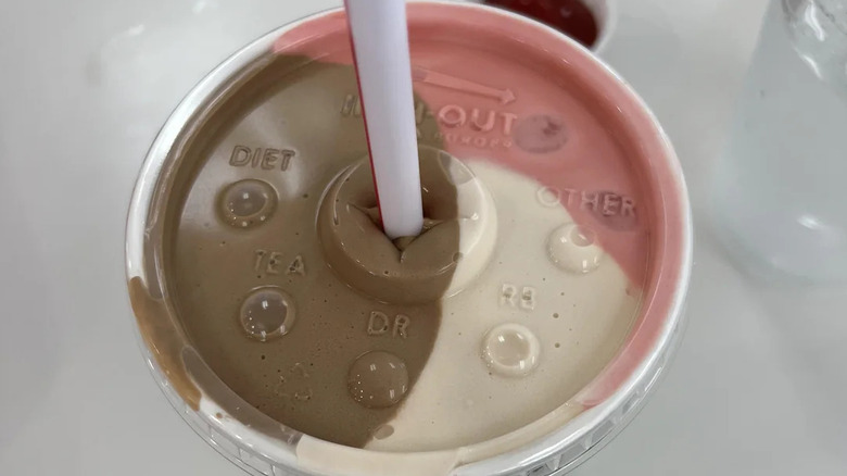 In-N-Out neapolitan shake showing all three flavors - chocolate, vanilla, and strawberry - clearly, the cup placed on a white counter.