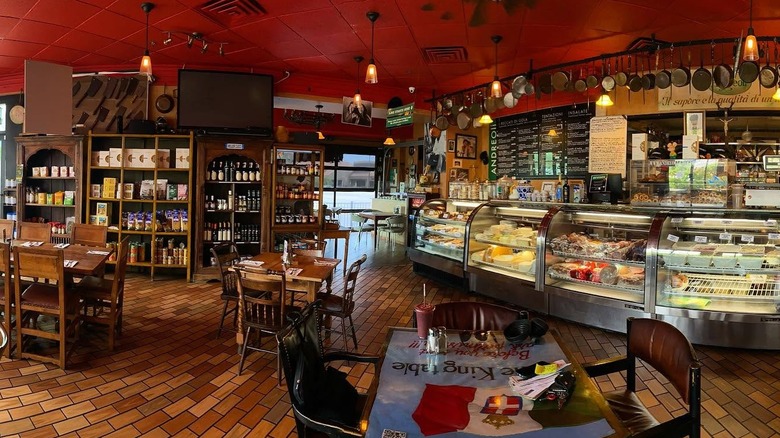 Dining area of Andreoli's surrounded by market goods and an order counter